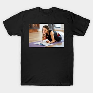 Young woman reading a yoga book T-Shirt